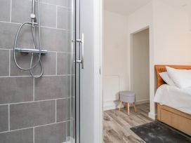 A bathroom with a shower and a bedroom view at Talgais in Llangollen