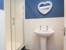 A bathroom with a shower and sink at Talgais in Llangollen