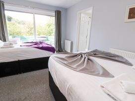 A bedroom with two beds and a view of the outside at Talgais in Llangollen