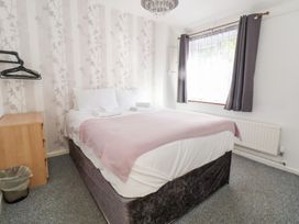 A bedroom with a bed and window at Talgais Llangollen