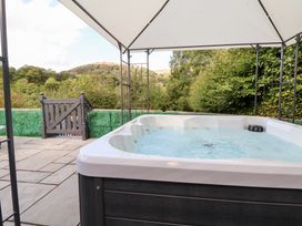 An outdoor area with a hot tub and gazebo at Talgais Llangollen