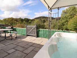An outdoor area with a hot tub and seating at Talgais in Llangollen