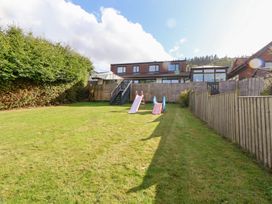 A garden with slides and grass at Talgais in Llangollen