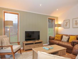 A living room with a sofa and television at 6 Hedgerows in Lanreath