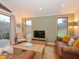 A living room with a sofa and television at 6 Hedgerows in Lanreath