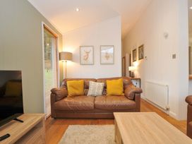 A living room with a sofa and television at 6 Hedgerows in Lanreath