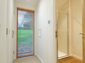 A bathroom with a shower and window at 6 Hedgerows in Lanreath