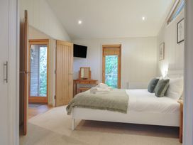 A bedroom with a bed and a window at 2 Streamside in Looe