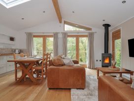 A living room with dining table and sofa at 2 Streamside in Lanreath