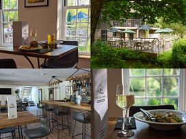 A dining area with tables and outdoor seating at The Old Mill in Lanreath