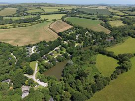 An aerial view of houses and fields at 6 Water's Edge in Lanreath