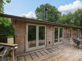A wooden cabin with a deck and outdoor seating at 14 Stonerush Valley, Lanreath
