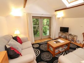 A living room with sofas and a television at Holemire Barn in Lorton