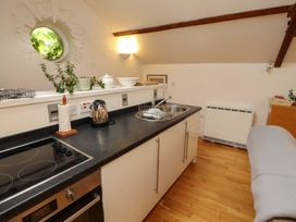 A kitchen with a stove and sink at Holemire Barn in Lorton