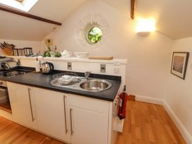 A kitchen with a sink and kettle at Holemire Barn in Lorton