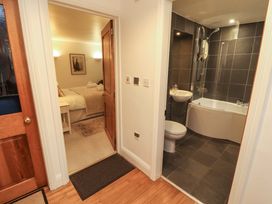 A bathroom with a bath tub and shower at Holemire Barn in Lorton