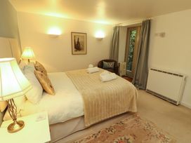 A bedroom with a bed and lamps at Holemire Barn in Lorton