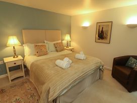 A bedroom with bed and nightstands at Holemire Barn in Lorton