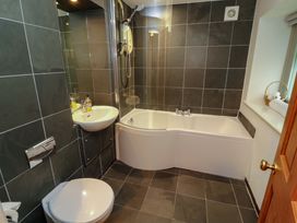 A bathroom featuring a bathtub, sink, and toilet at Holemire Barn in Lorton