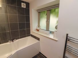 A bathroom with a bathtub and window at Holemire Barn in Lorton