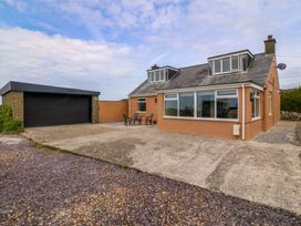 A house with a garage and seating area at Dalar Deg Aberdaron