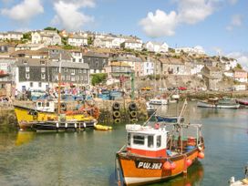 A harbor with boats and buildings at Captain's Cabin in Mevagissey