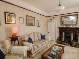 A living room with furniture and wall art at Cairbre House in Dungarvan, County Waterford