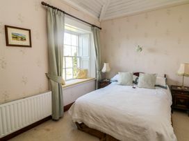 A bedroom with a bed and window at Cairbre House, Dungarvan, County Waterford