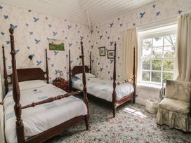 A bedroom with two beds and a window at Cairbre House in Dungarvan, County Waterford