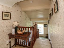 A hallway with a table and lamp at Cairbre House, Dungarvan, County Waterford