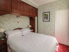 A bedroom with a bed and wardrobe at Cairbre House in Dungarvan, County Waterford
