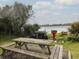 Outdoor seating area with picnic table and grills at Cairbre House Dungarvan, County Waterford