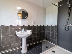 A bathroom with a sink and shower at Ty Berllan in Caersws