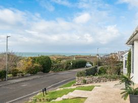A view of the sea and road with greenery at Chi An Mor in Porth