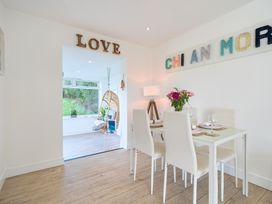 A dining room with a table set for meals at Chi An Mor in Porth