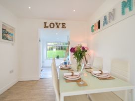A dining room with a table set for dinner at Chi An Mor in Porth