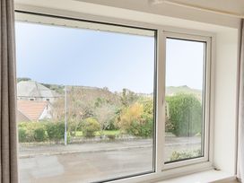 A view from a window showing houses and landscaping at Chi An Mor in Porth