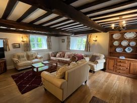 A living room with sofas and a coffee table at Ivy Cottage in West Lulworth
