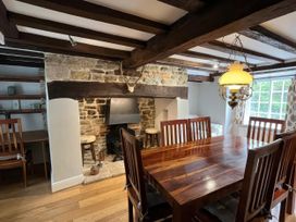 A dining room with table and chairs at Ivy Cottage in West Lulworth