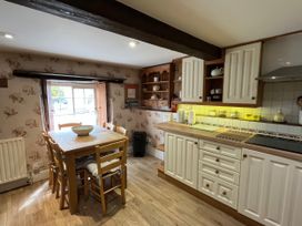A kitchen with a table and chairs at Ivy Cottage in West Lulworth