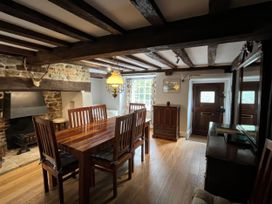 A dining room with a table and chairs at Ivy Cottage in West Lulworth