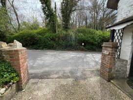 An outdoor view of a road and greenery at Ivy Cottage in West Lulworth