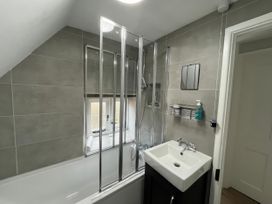 A bathroom with a bathtub and sink at Little Ivy in West Lulworth