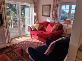 A living room with a sofa and armchair at Little Retreat in Upwey