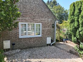 An outdoor space with a brick wall and window at Little Retreat in Upwey