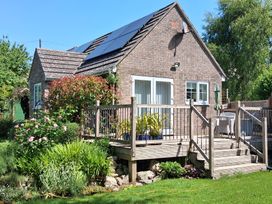 A house with a deck and garden at Little Retreat in Upwey