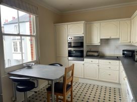 A kitchen with a table and chairs at Mutiny House in Brewers Quay Harbour