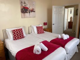 A bedroom with two beds and a painting at Mutiny House Brewers Quay Harbour