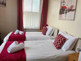 A bedroom with two beds and a window at Mutiny House Brewers Quay Harbour