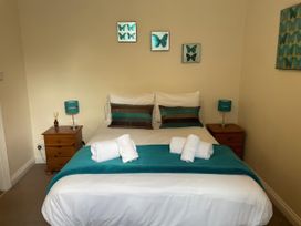A bedroom with a bed and nightstands at Mutiny House in Brewers Quay Harbour